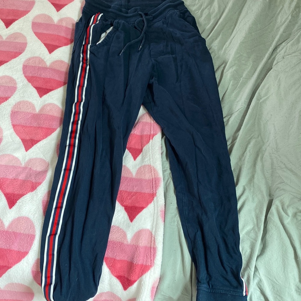 Blue small cargo pants with red and white stripes on both sides